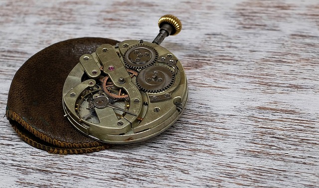 watchmaker documenting intake photos and notes in a dark studio